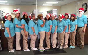 Darien Pharmacy employees wearing Christmas hats for promos that will run this December.